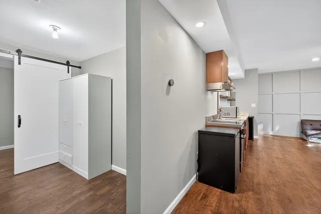 a view of kitchen with furniture and wooden floor