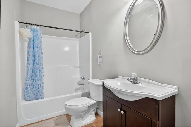 a bathroom with a sink toilet and a mirror