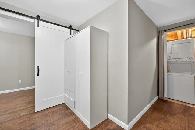 a view of closet area with wooden floor