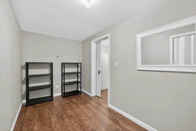 a view of an empty room with a closet