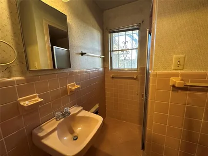 a bathroom with a sink toilet and mirror