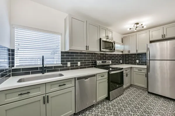 a kitchen with a sink stove and refrigerator