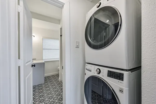 a view of a storage and utility room with washer and dryer