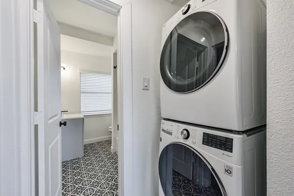 a view of a storage and utility room with washer and dryer