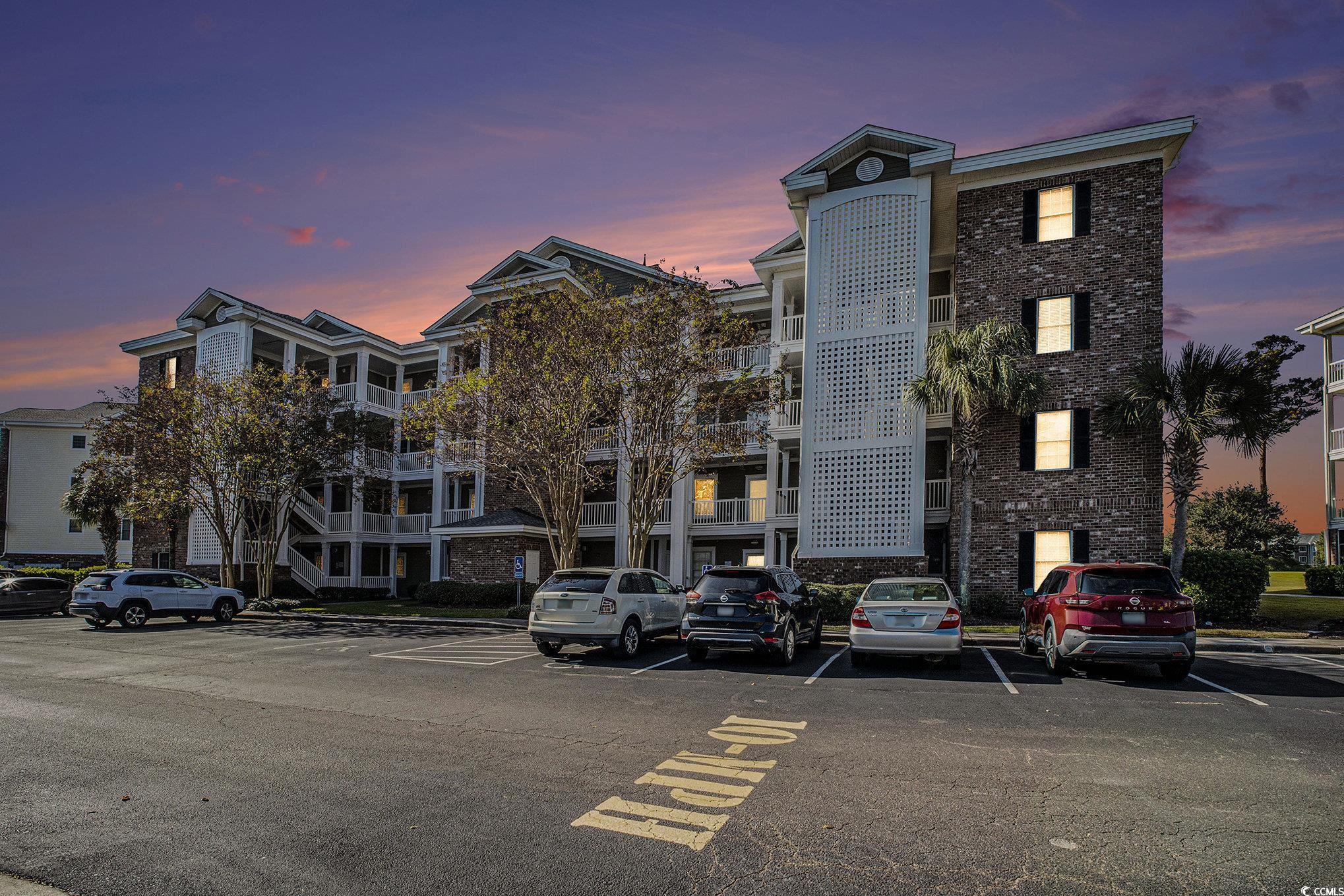 4894 Luster Leaf Circle, Unit 303 Myrtle Beach, SC 29577 - Photo 1 of 31 Property at dusk featuring uncovered parking