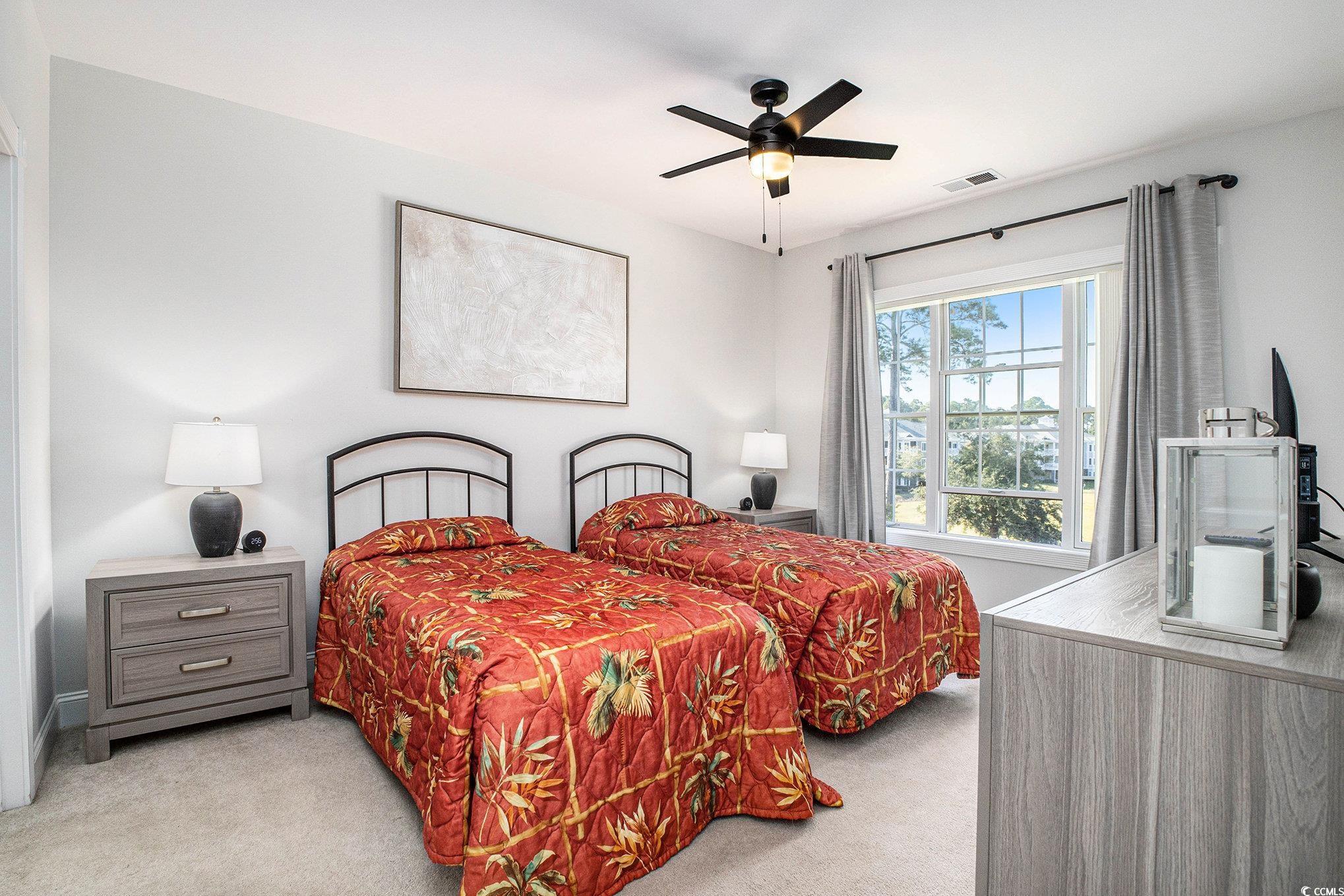 4894 Luster Leaf Circle, Unit 303 Myrtle Beach, SC 29577 - Photo 15 of 31 Bedroom featuring light colored carpet and a ceiling fan