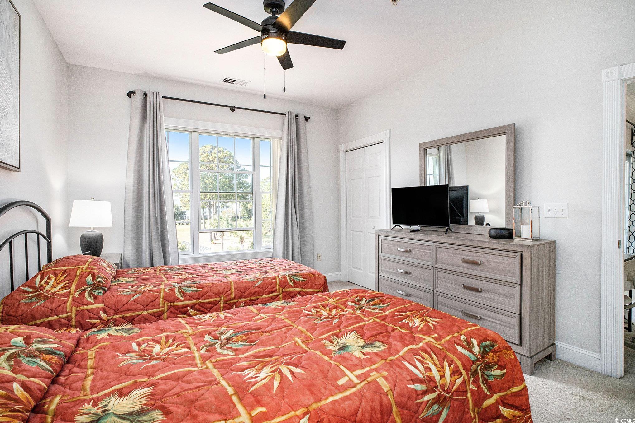 4894 Luster Leaf Circle, Unit 303 Myrtle Beach, SC 29577 - Photo 16 of 31 Bedroom featuring light colored carpet and ceiling fan