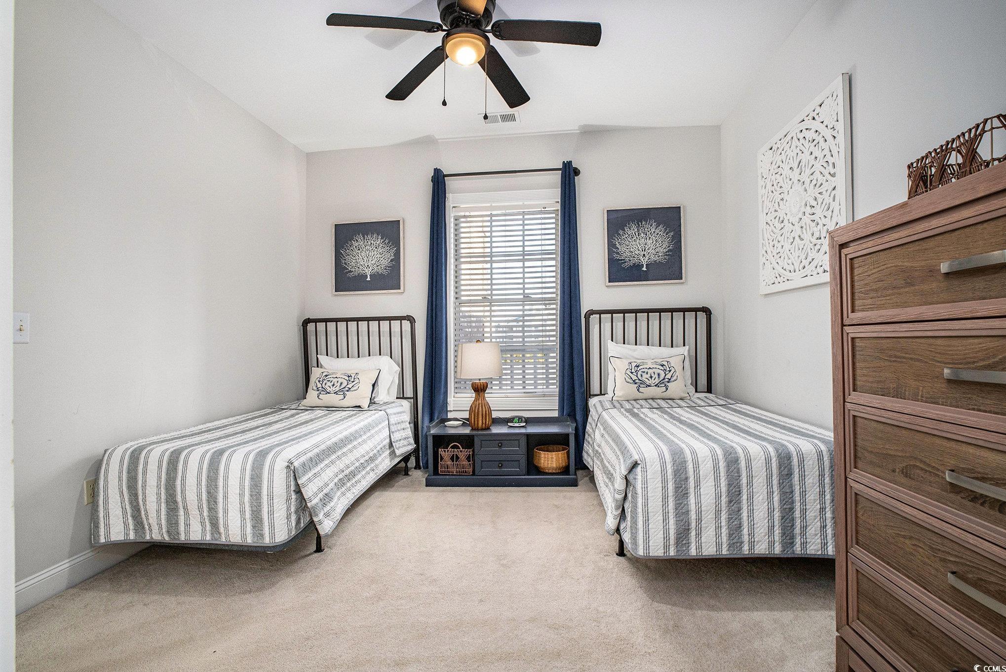 4894 Luster Leaf Circle, Unit 303 Myrtle Beach, SC 29577 - Photo 19 of 31 Bedroom featuring light carpet and a ceiling fan