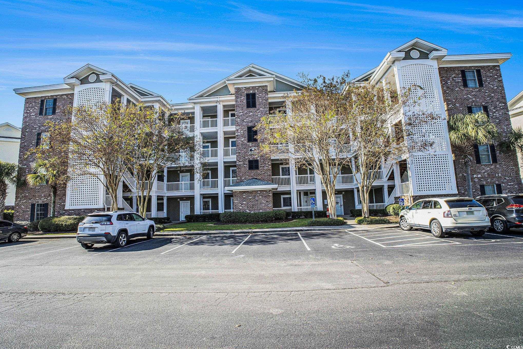 4894 Luster Leaf Circle, Unit 303 Myrtle Beach, SC 29577 - Photo 2 of 31 View of apartment building / complex with uncovered parking