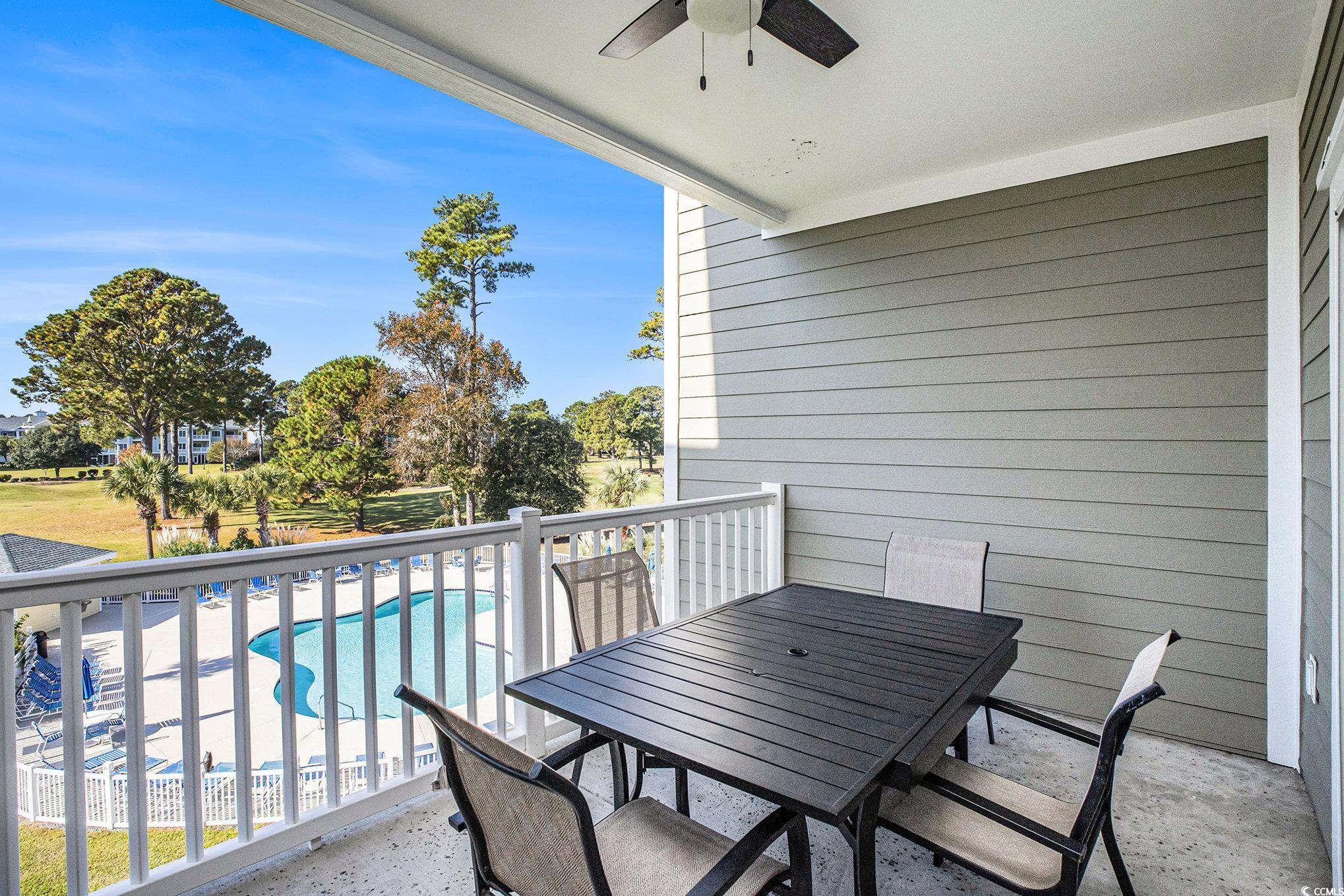4894 Luster Leaf Circle, Unit 303 Myrtle Beach, SC 29577 - Photo 24 of 31 Balcony with ceiling fan, view of pool area, and outdoor dining area