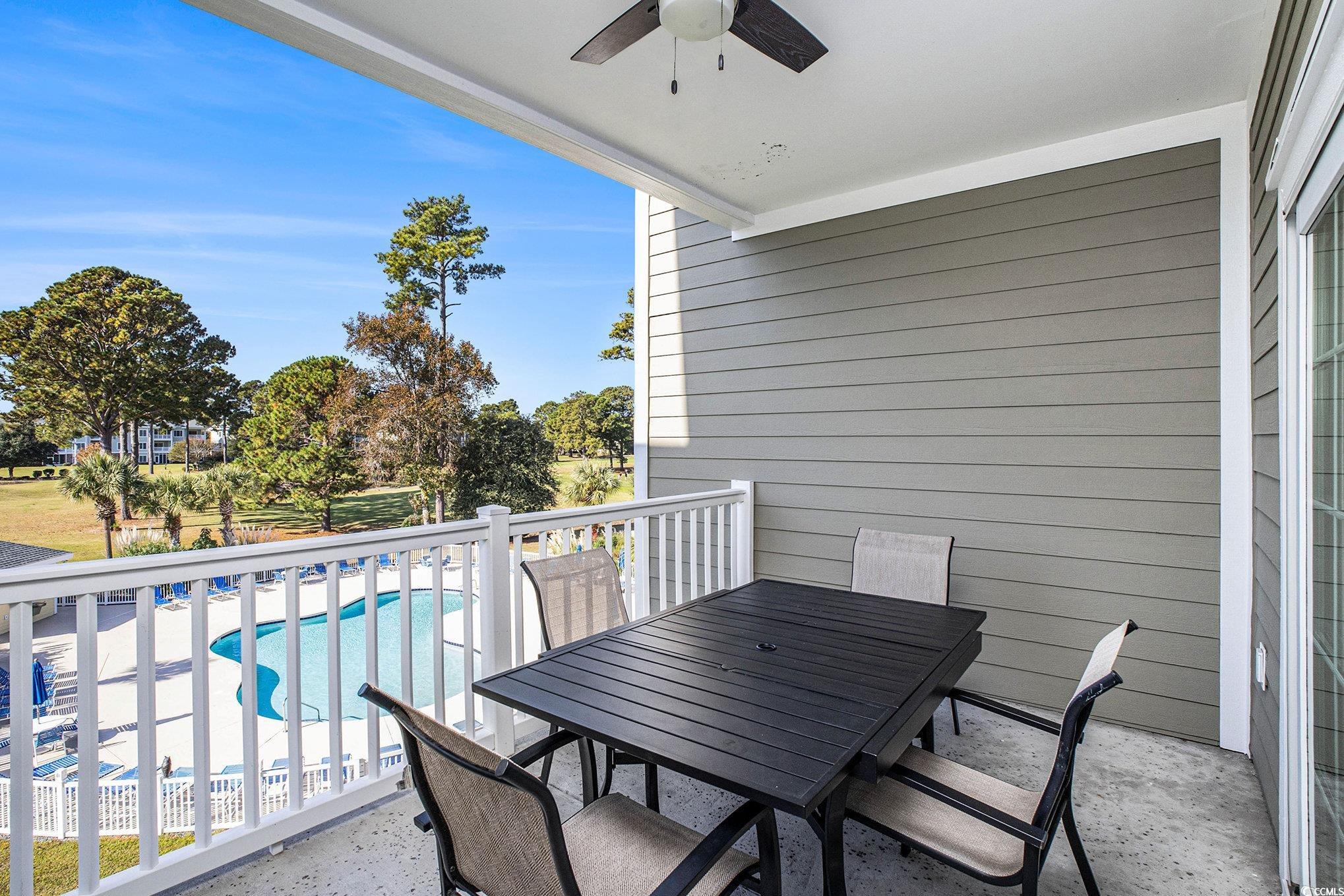 4894 Luster Leaf Circle, Unit 303 Myrtle Beach, SC 29577 - Photo 25 of 31 Balcony with a ceiling fan, view of pool area, and outdoor dining area