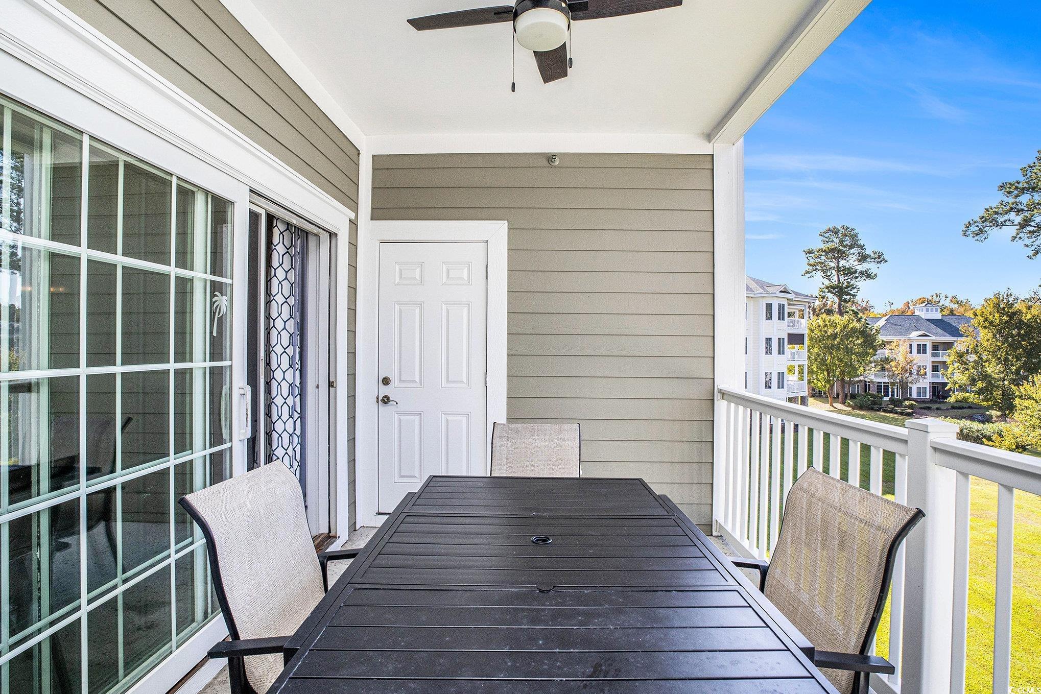 4894 Luster Leaf Circle, Unit 303 Myrtle Beach, SC 29577 - Photo 26 of 31 Balcony featuring a ceiling fan and outdoor dining area