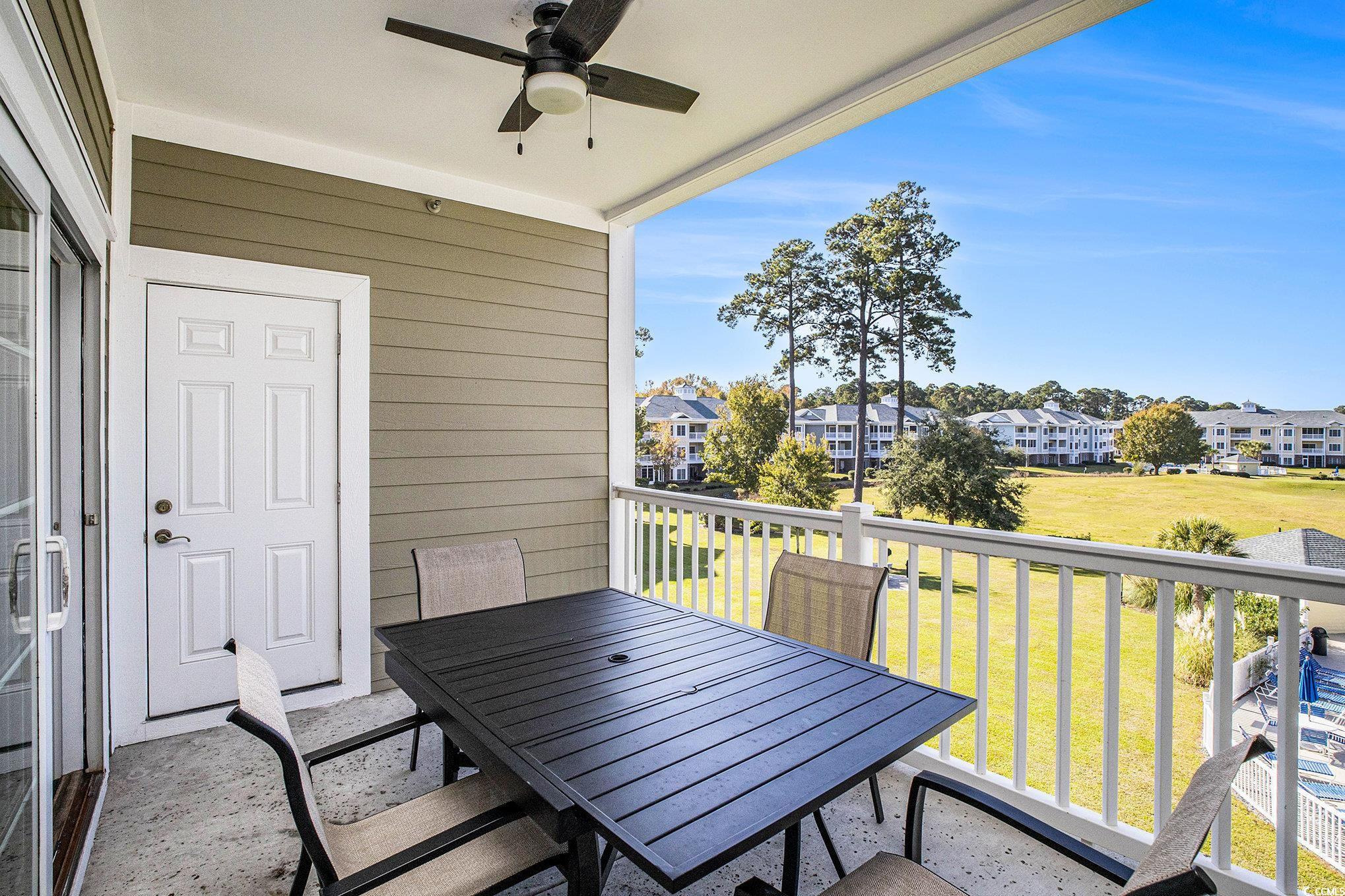 4894 Luster Leaf Circle, Unit 303 Myrtle Beach, SC 29577 - Photo 27 of 31 Balcony featuring outdoor dining area, a ceiling fan, and a sunroom