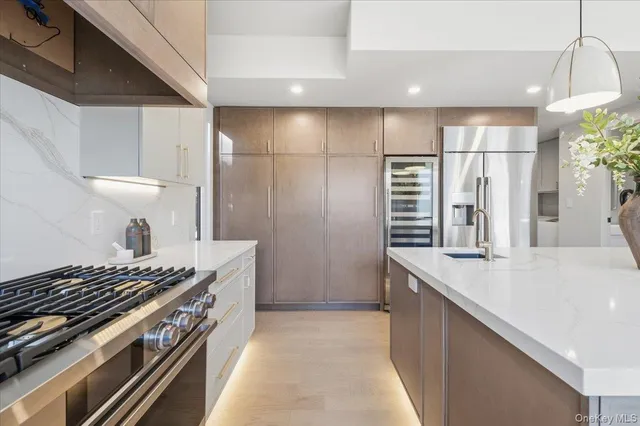 a kitchen with stainless steel appliances granite countertop a stove and a refrigerator