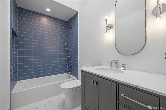 a bathroom with a sink a toilet and bathtub