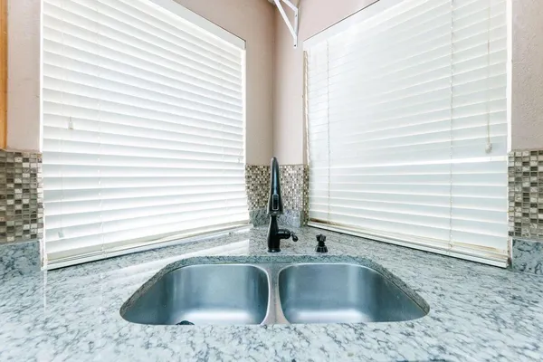 a kitchen with granite countertop a sink and a window