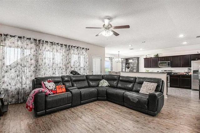 a living room with furniture and kitchen view