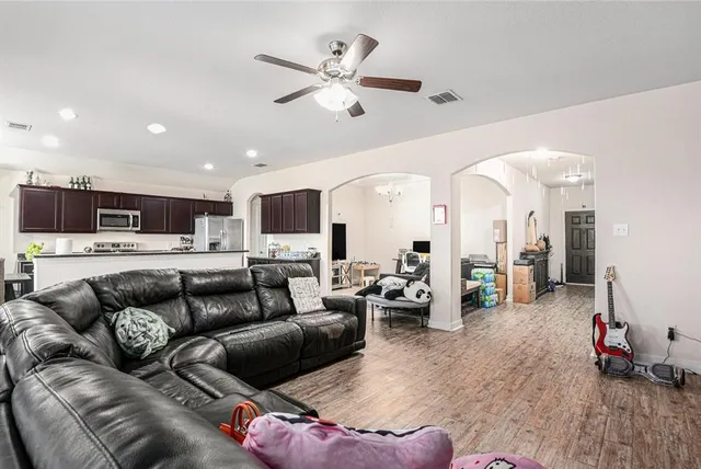 a living room with furniture and kitchen view