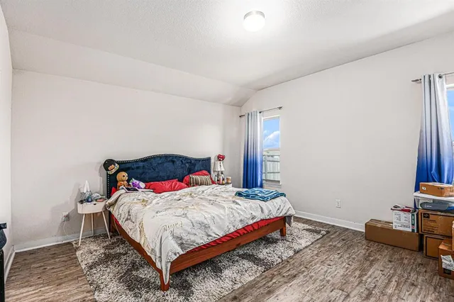 a bedroom with a bed and a table in it