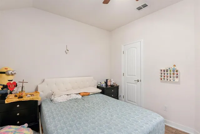 a bedroom with a bed and cabinets