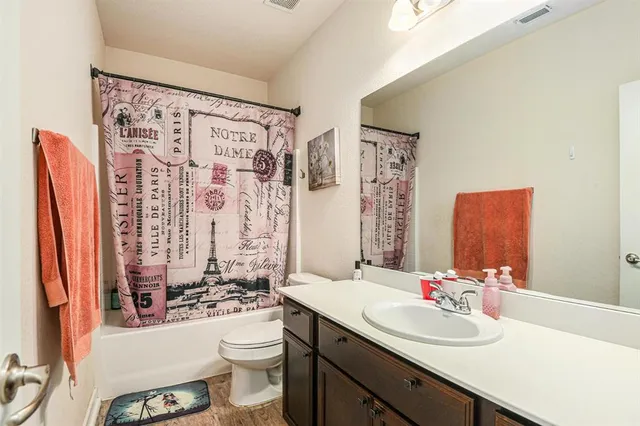 a bathroom with a sink toilet and shower