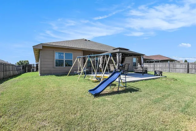 a view of a house with a backyard