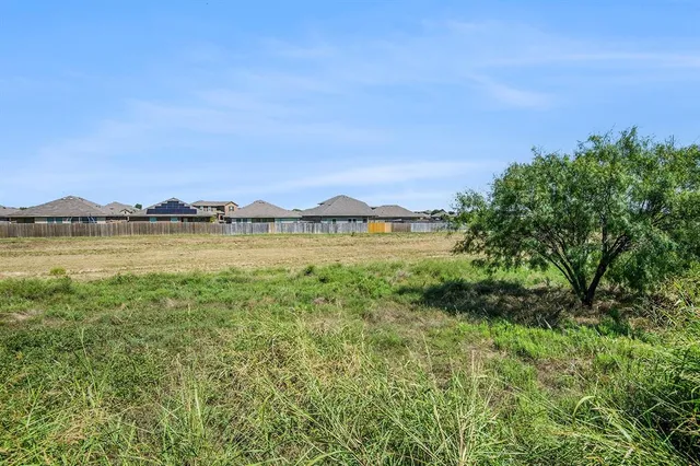 a view of a lake with houses in the back