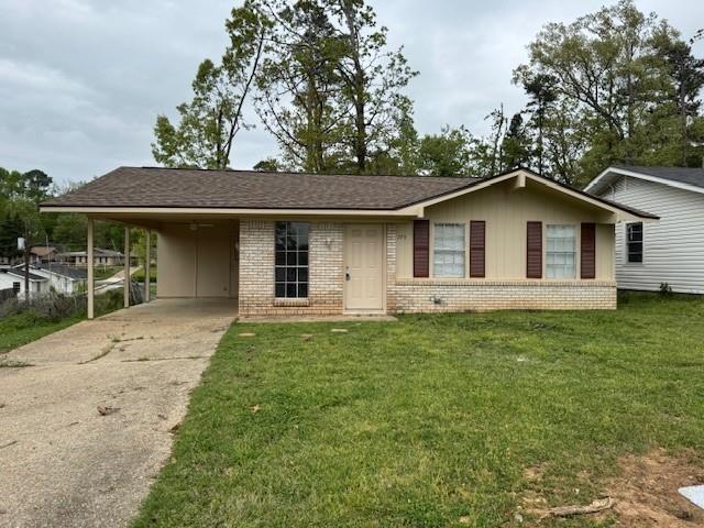 773 Randy Lane Haughton, LA 71037 - Photo 1 of 1 Ranch-style house with roof with shingles, driveway, a front lawn, brick siding, and a carport