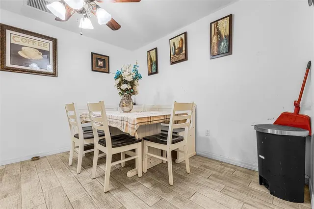 a dining room with furniture and wooden floor