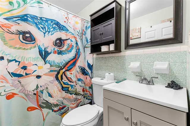 a bathroom with a sink and mirror with toilet