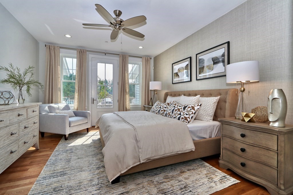 73 Rowell Road, Unit 73 Middleton , MA 01923 - Photo 18 of 40 a bedroom with a bed and wooden floor