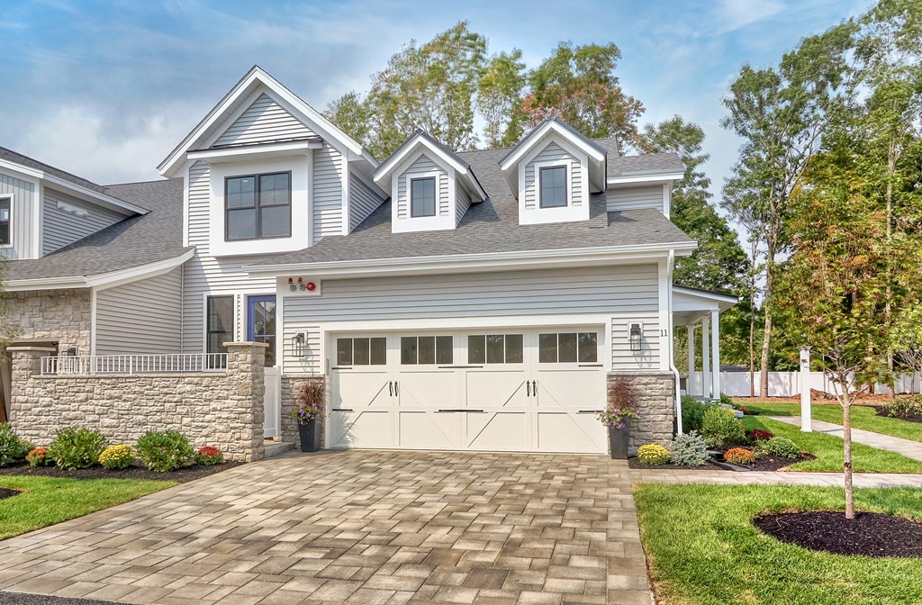 73 Rowell Road, Unit 73 Middleton , MA 01923 - Photo 2 of 40 a front view of a house with a yard and garage