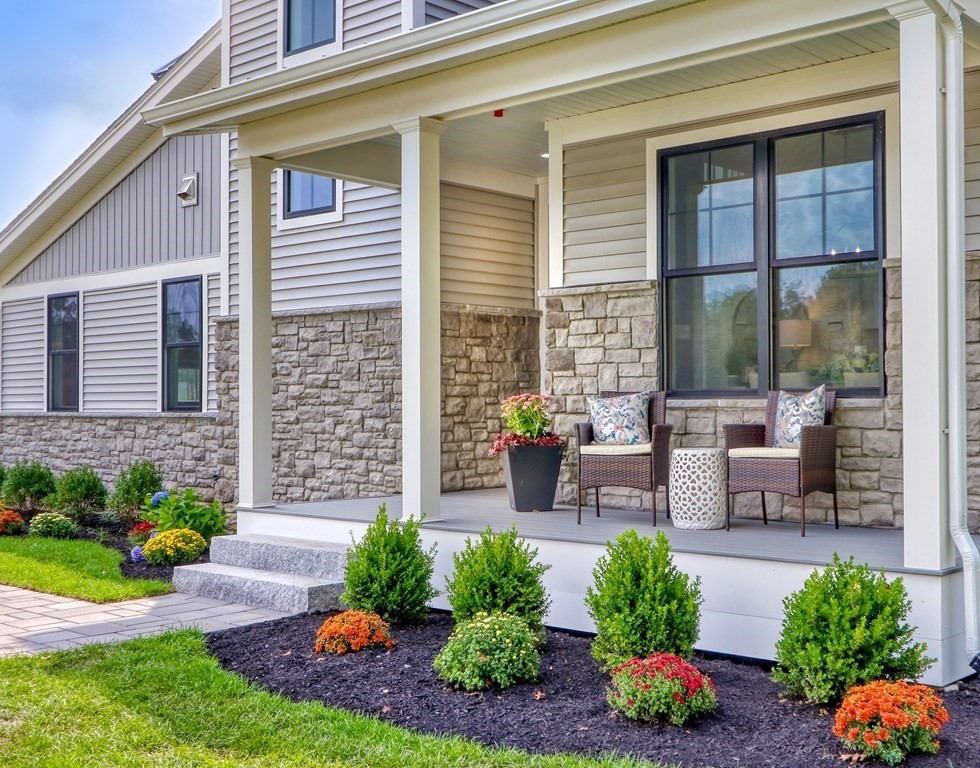 73 Rowell Road, Unit 73 Middleton , MA 01923 - Photo 3 of 40 a front view of a house with outdoor seating and a garden