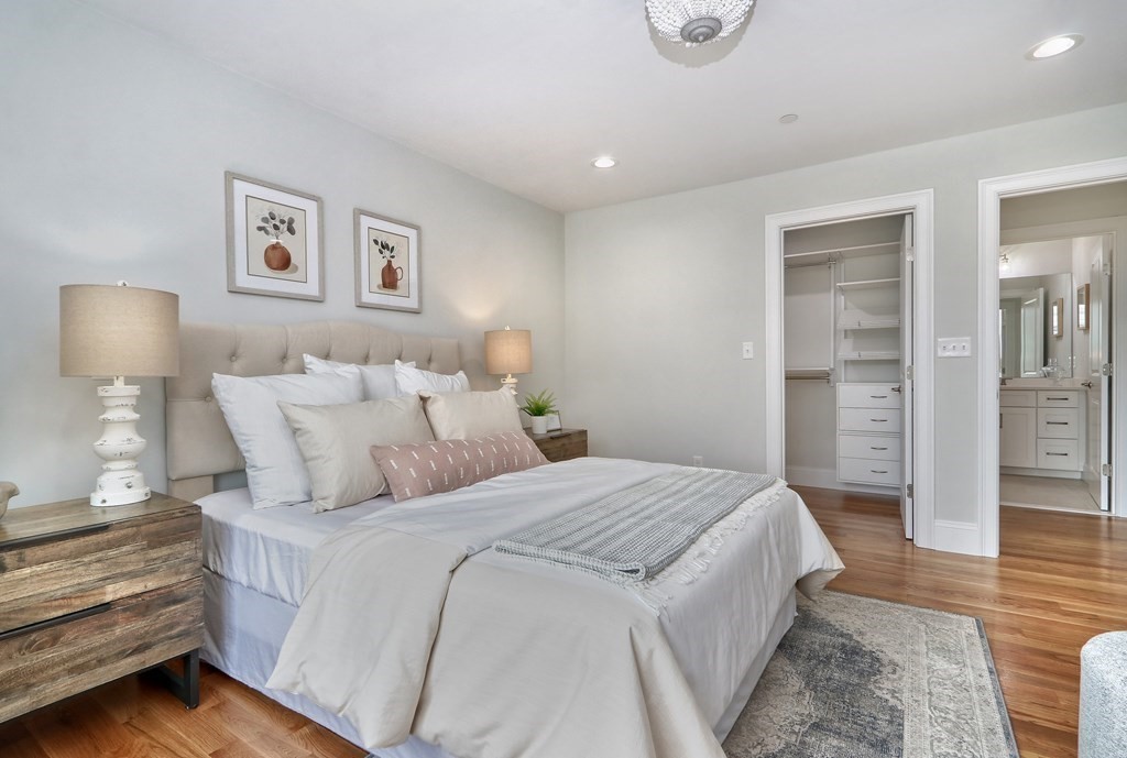 73 Rowell Road, Unit 73 Middleton , MA 01923 - Photo 32 of 40 a spacious bedroom with a bed and lamp