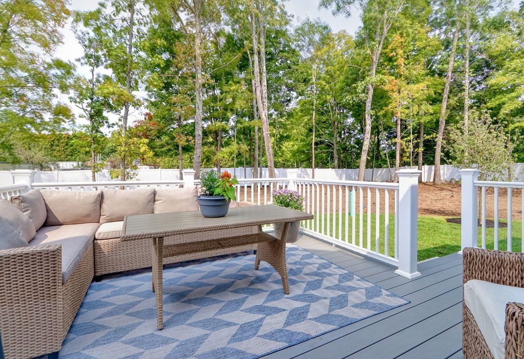 73 Rowell Road, Unit 73 Middleton , MA 01923 - Photo 36 of 40 a view of a deck with couches and wooden floor
