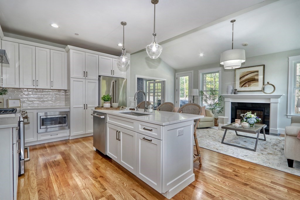 73 Rowell Road, Unit 73 Middleton , MA 01923 - Photo 7 of 40 a kitchen with stainless steel appliances granite countertop a stove a refrigerator a oven a sink with a dining table and chairs