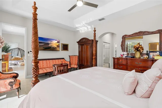 a bedroom with a bed and a large mirror with a flat tv screen