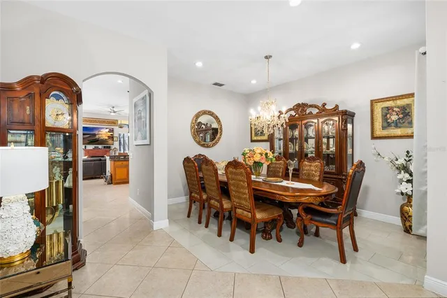 a view of a dining room with furniture and chandelier