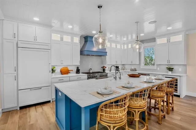 a kitchen with granite countertop a sink a counter top space and living room view