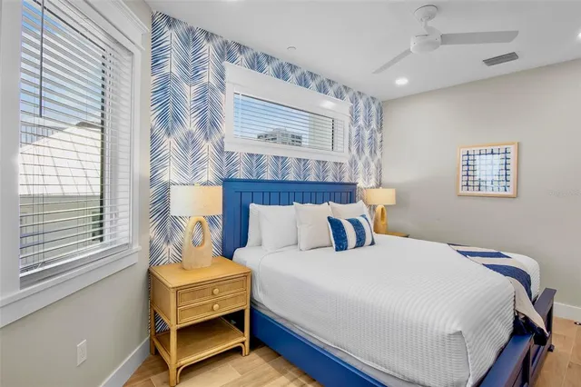 a bedroom with a large bed and a large window