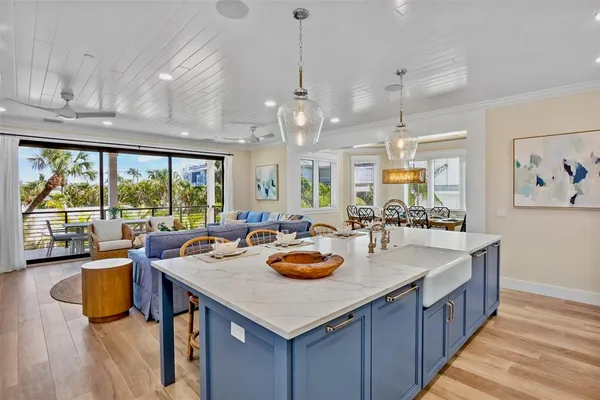 a living room with furniture kitchen and a chandelier