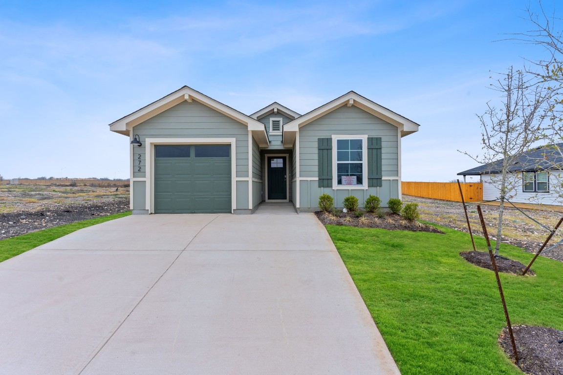 272 Celosia Loop Kyle, TX 78640 - Photo 1 of 12 a view of a house with a yard and large tree