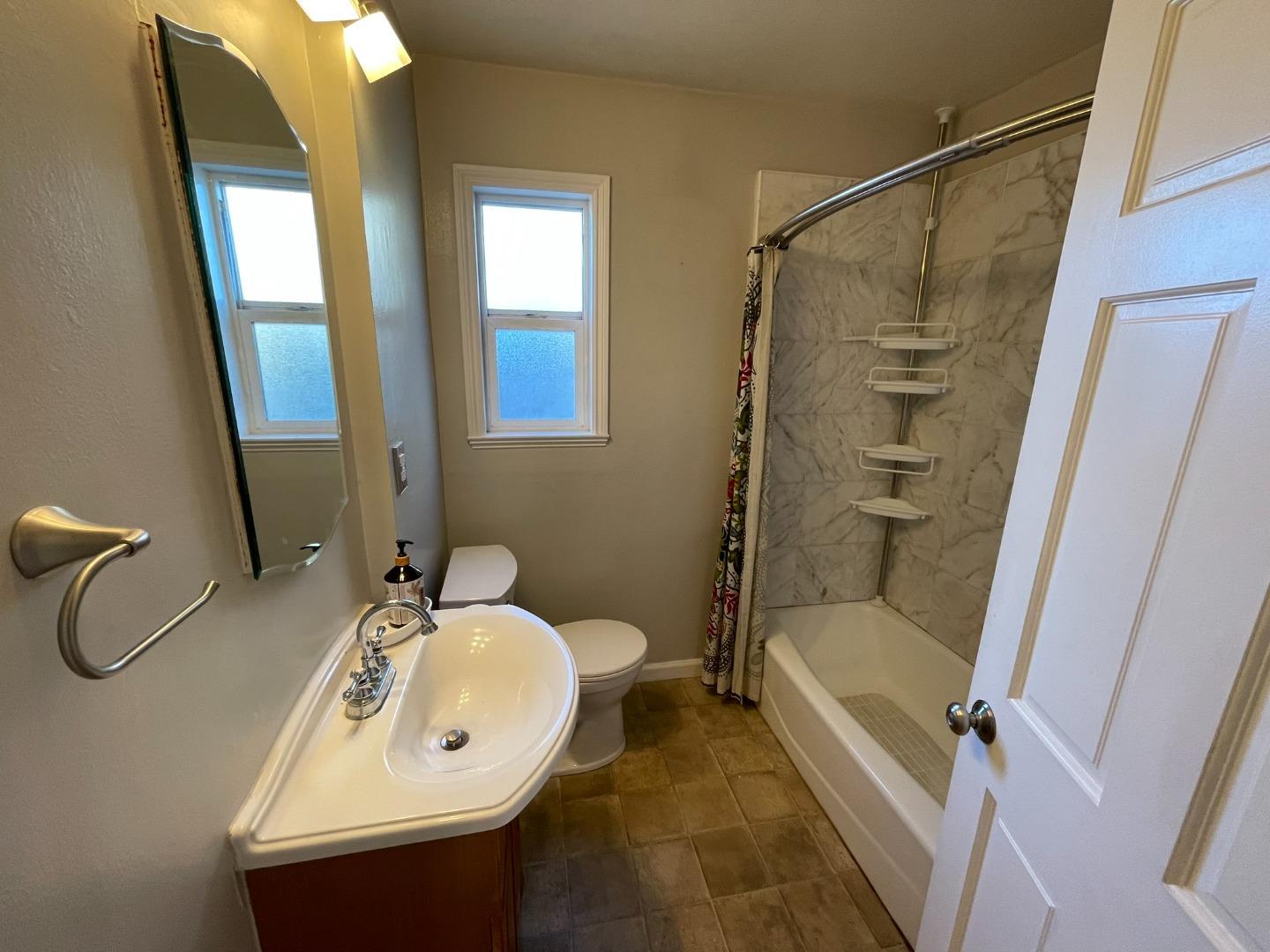 3709 Casanova Drive San Mateo, CA 94403 - Photo 5 of 13 a bathroom with a sink and mirror with bathtub