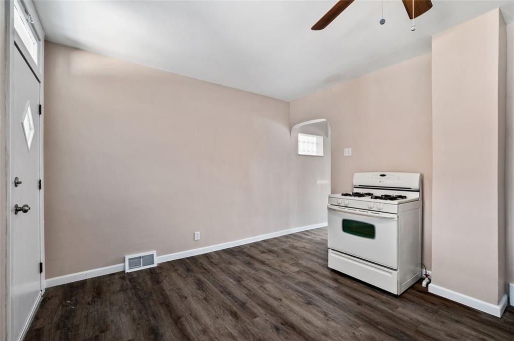 800 State Street Duquesne, PA 15110 - Photo 11 of 27 a kitchen with a wooden floor and white stove