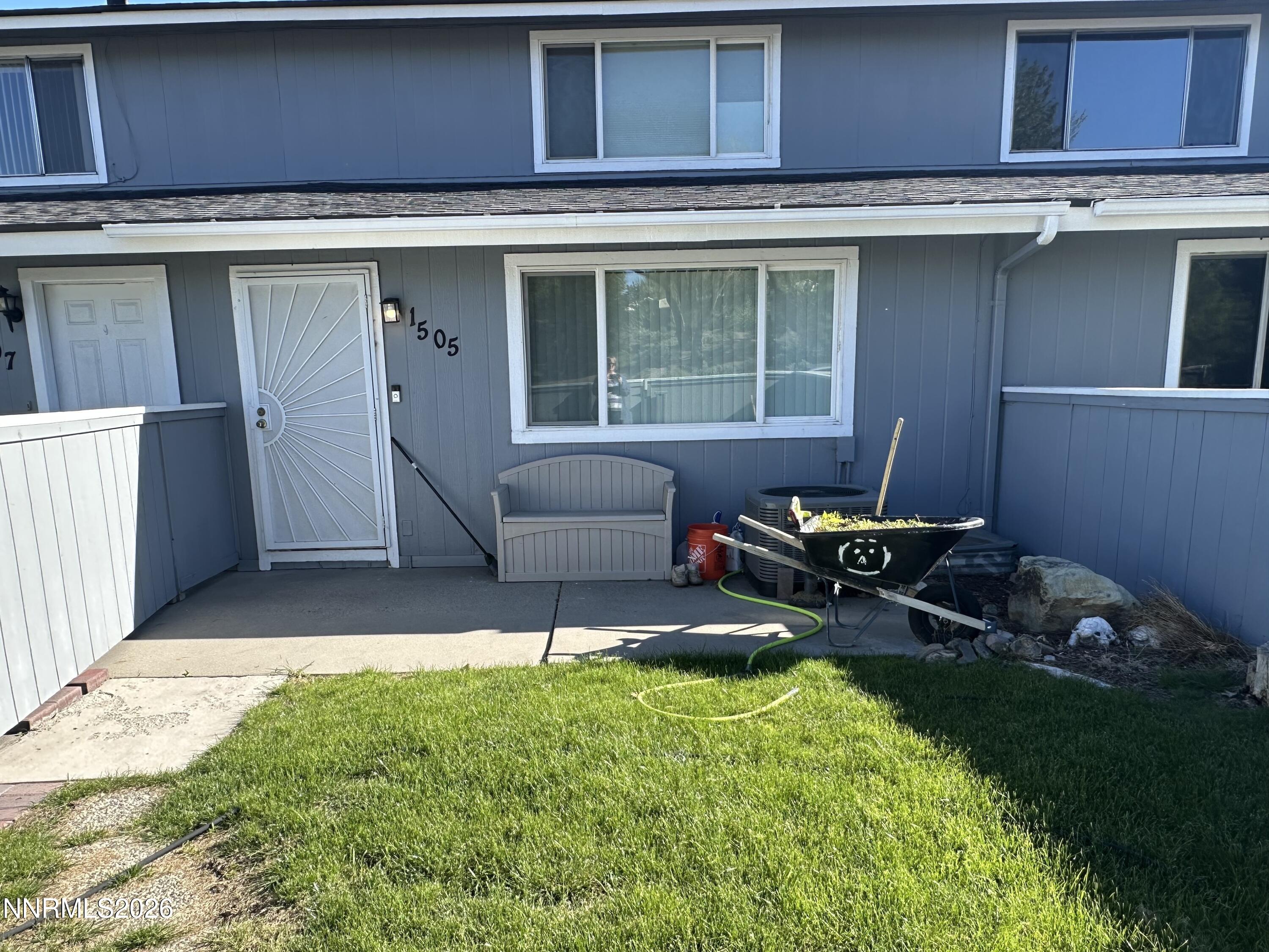 a backyard of a house with table and chairs
