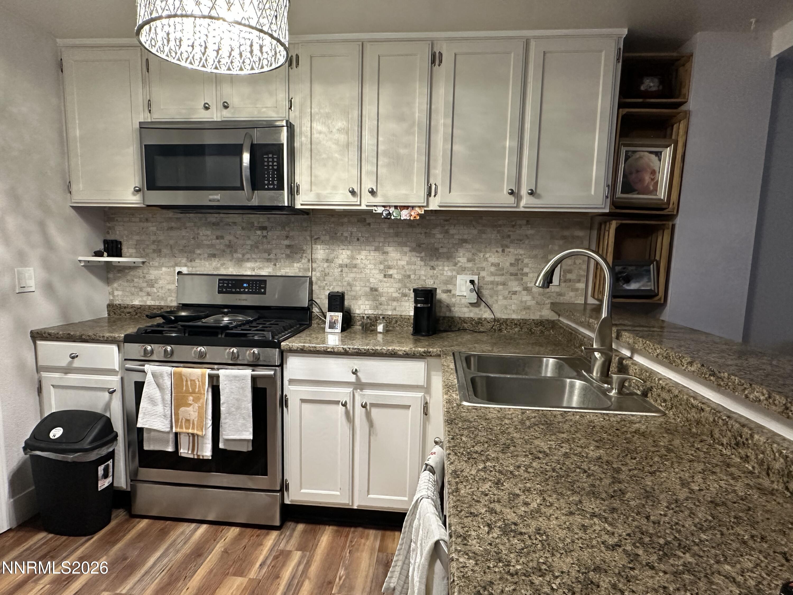 1505 East Long Street Carson City, NV 89706 - Photo 2 of 4 a kitchen with stainless steel appliances granite countertop a stove a microwave and a sink