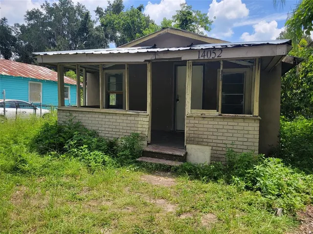 a view of brick house with large windows