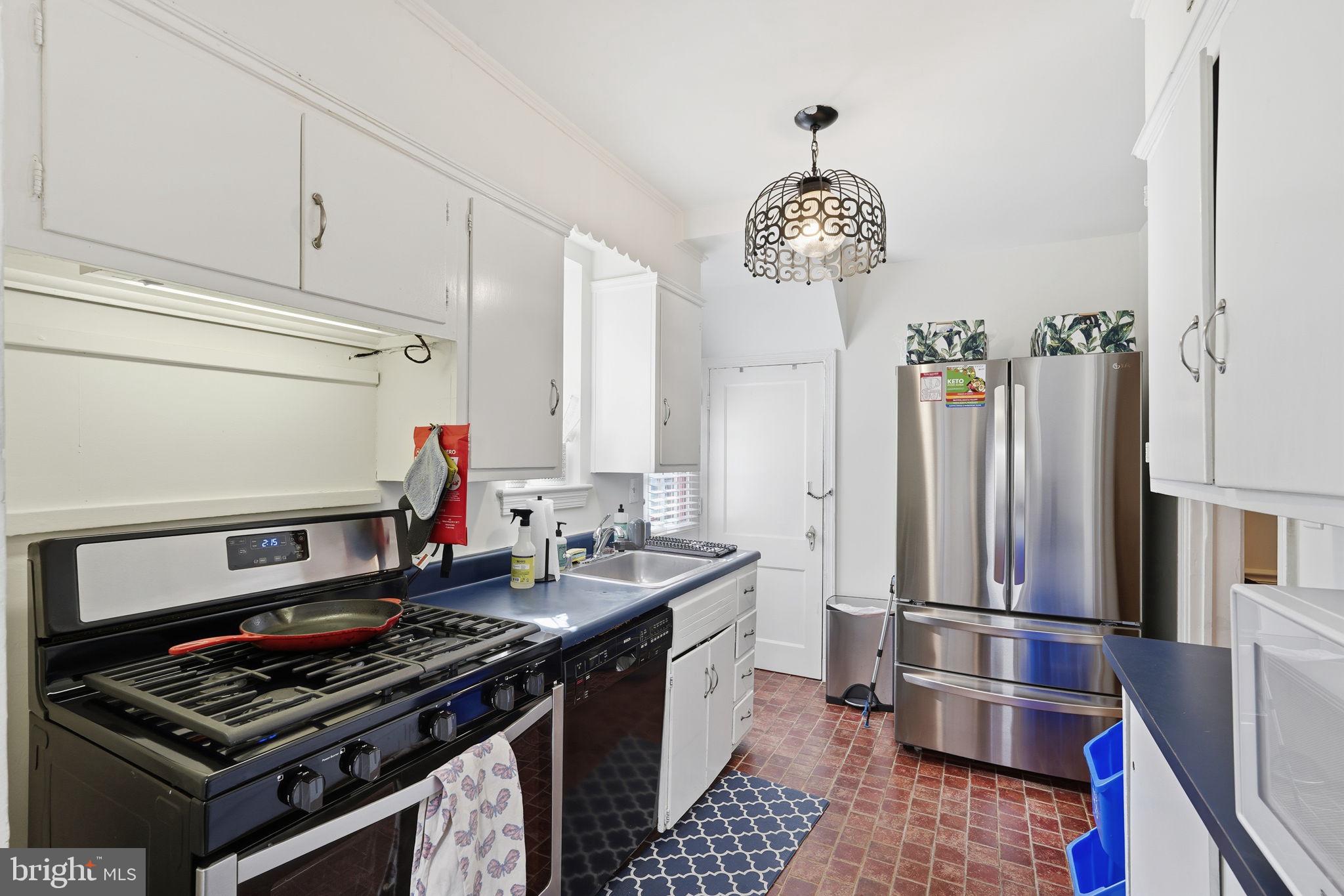 8209 Meadowbrook Lane Chevy Chase, MD 20815 - Photo 14 of 24 a kitchen with stainless steel appliances a stove a sink and a refrigerator