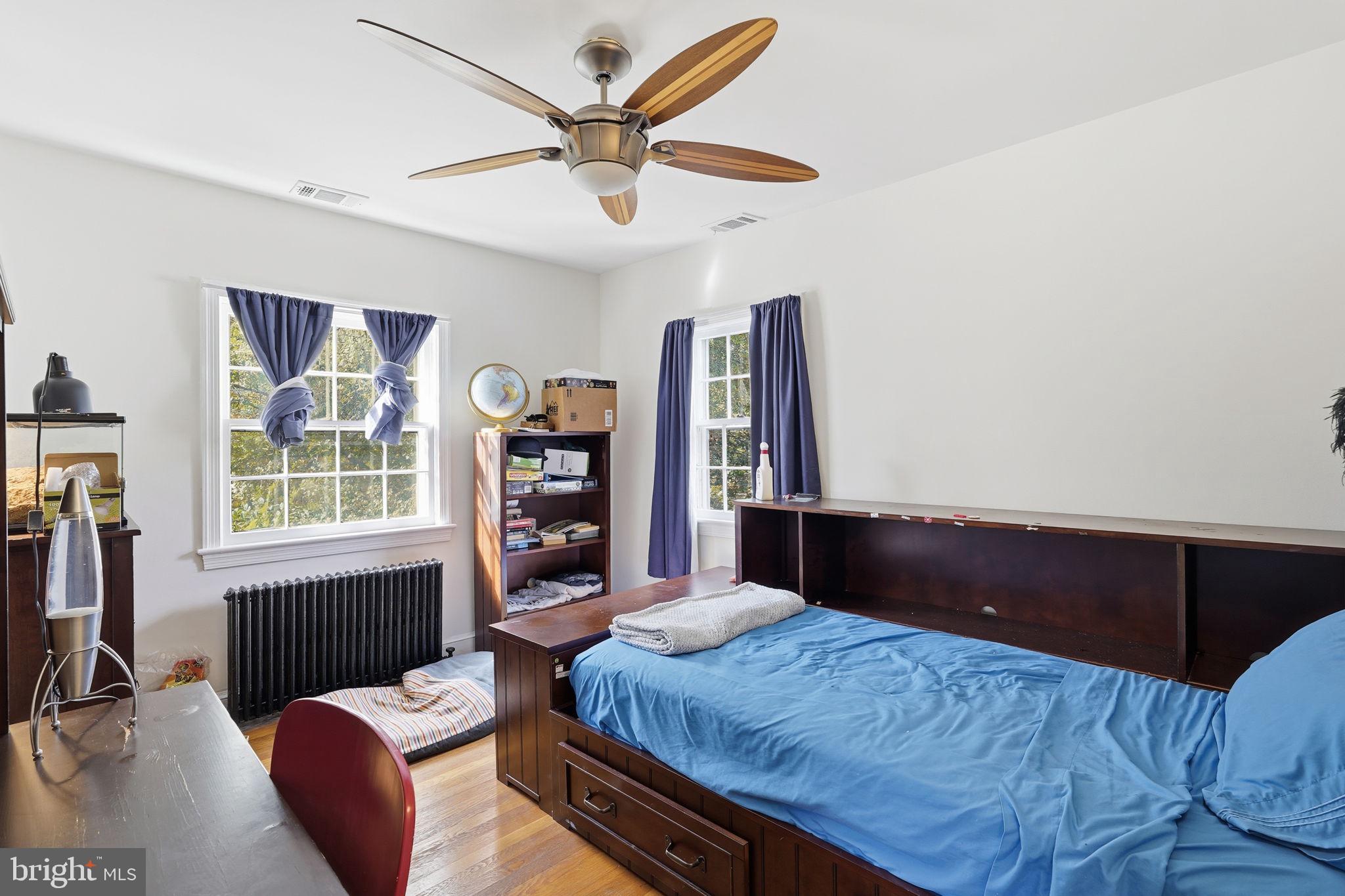 8209 Meadowbrook Lane Chevy Chase, MD 20815 - Photo 18 of 24 a bedroom with a bed window and a flat screen tv