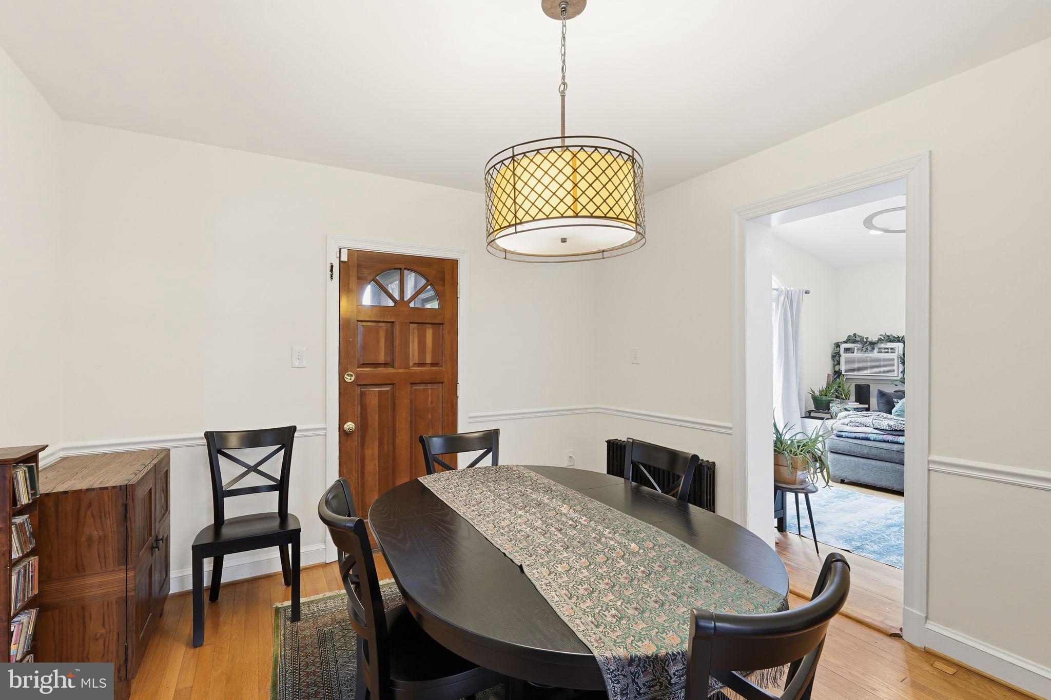 8209 Meadowbrook Lane Chevy Chase, MD 20815 - Photo 4 of 24 a view of a dining room with furniture wooden floor and a chandelier